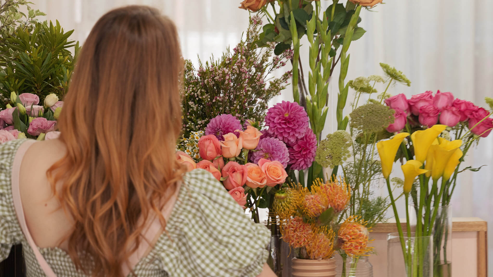 A lady arranging flowers in retail store - Poppy Rose Flowers Brisbane