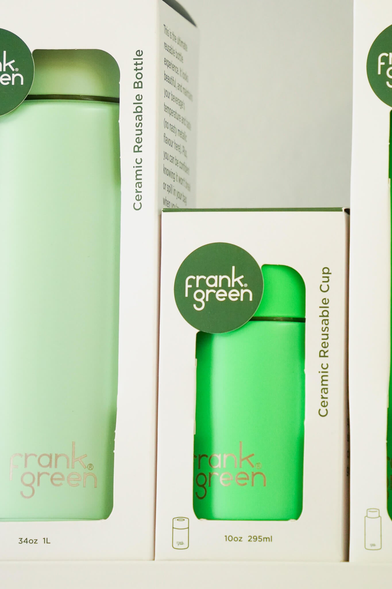 Frank Green ceramic reusable bottles and cups displayed in minimalist white packaging with green accents and branding.